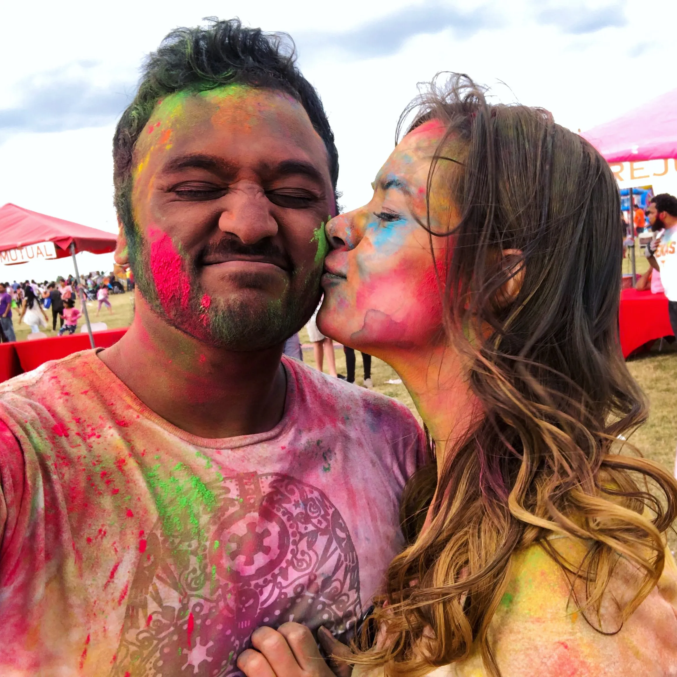 Brianna and Ivan smiling close together in a square portrait.